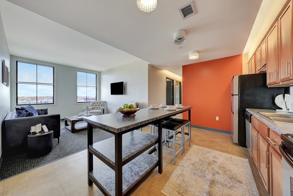 an open kitchen and living room with a dining room table at Parkhaus Apartments,Nebraska