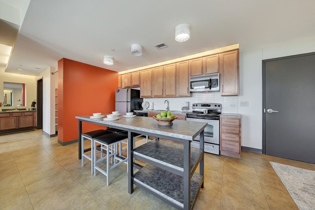 a kitchen with a center island and stainless steel appliances a kitchen with a center island and stainless steel appliances at Parkhaus Apartments, Lincoln