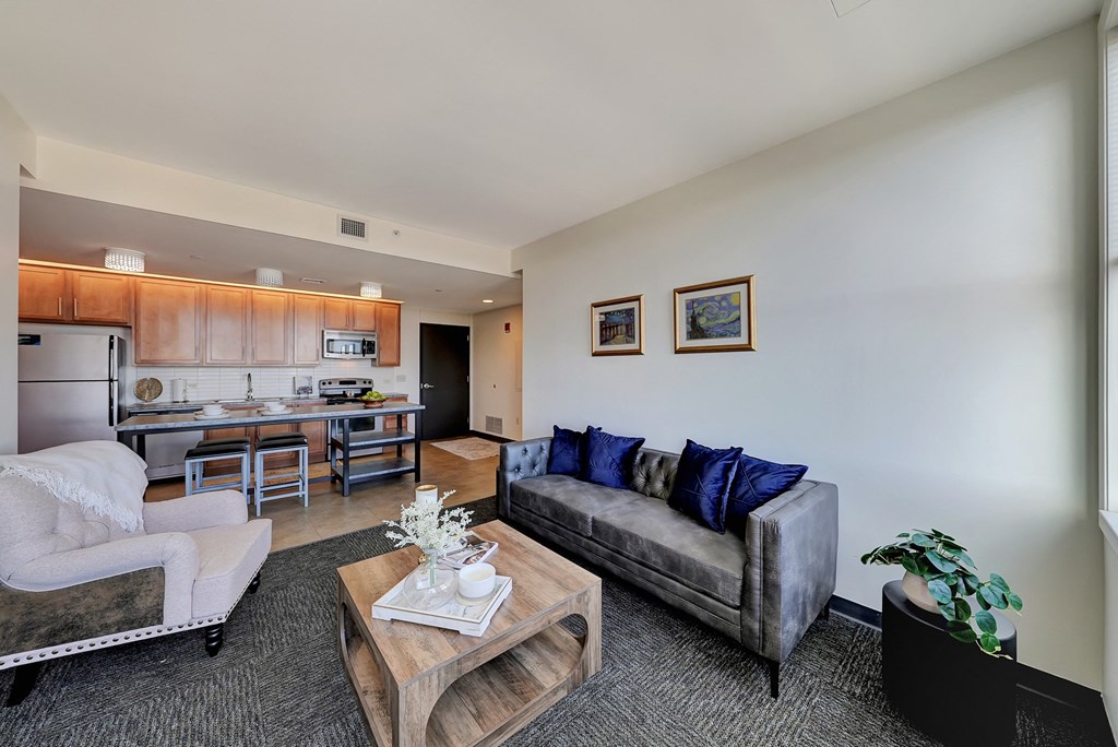 a living room with a couch and a coffee table and a kitchen at Parkhaus Apartments, Lincoln