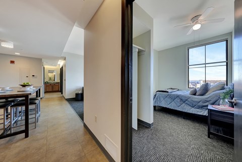 the view of a living room and bedroom from the hallway of an apartment at Parkhaus Apartments, Lincoln, NE 68508