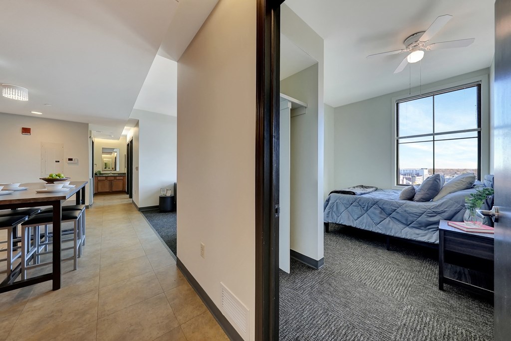 the view of a living room and bedroom from the hallway of an apartment the view of a living room and bedroom from the hallway of an apartment at Parkhaus Apartments, Lincoln, NE 68508