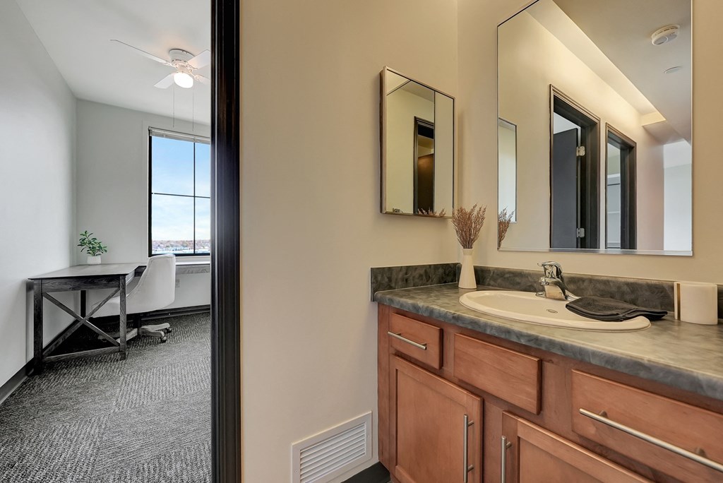 the view of a bathroom with a sink and a mirror from the doorway at Parkhaus Apartments,Nebraska 68508