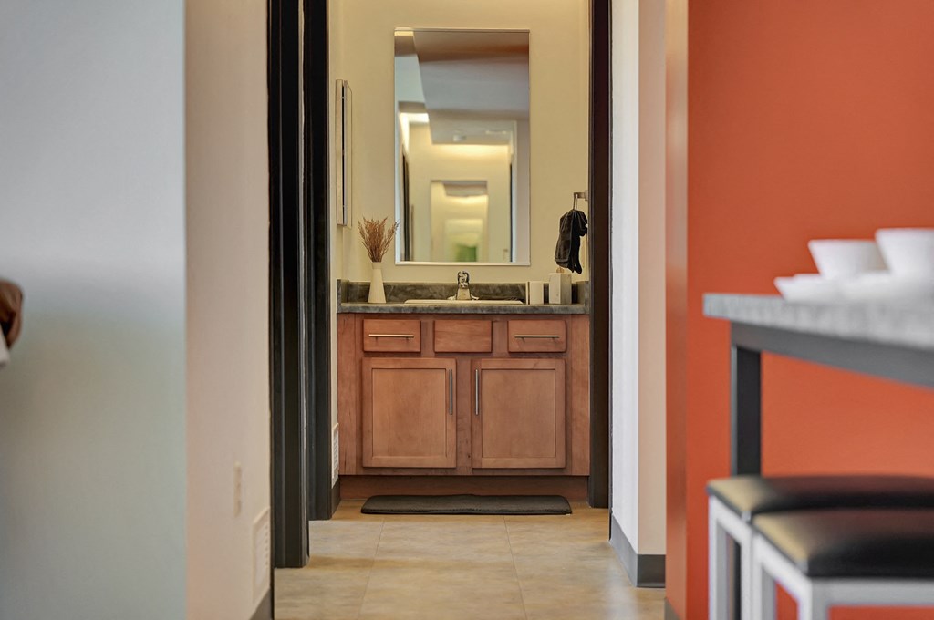 a view of a bathroom with a sink and a mirror at Parkhaus Apartments, Lincoln, Nebraska