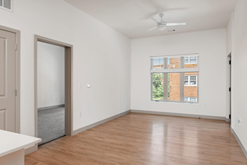 A room with a ceiling fan and a window with blinds.at Converge KC Uptown, Kansas City Missouri