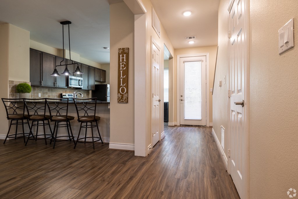 view of the kitchen and living room from the hallway of an apartment