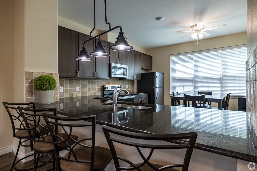 an open kitchen and dining area with a table and chairs