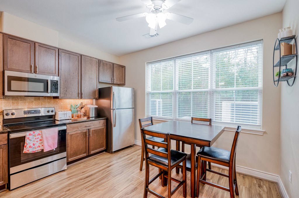 an empty kitchen and dining room with a table and chairs