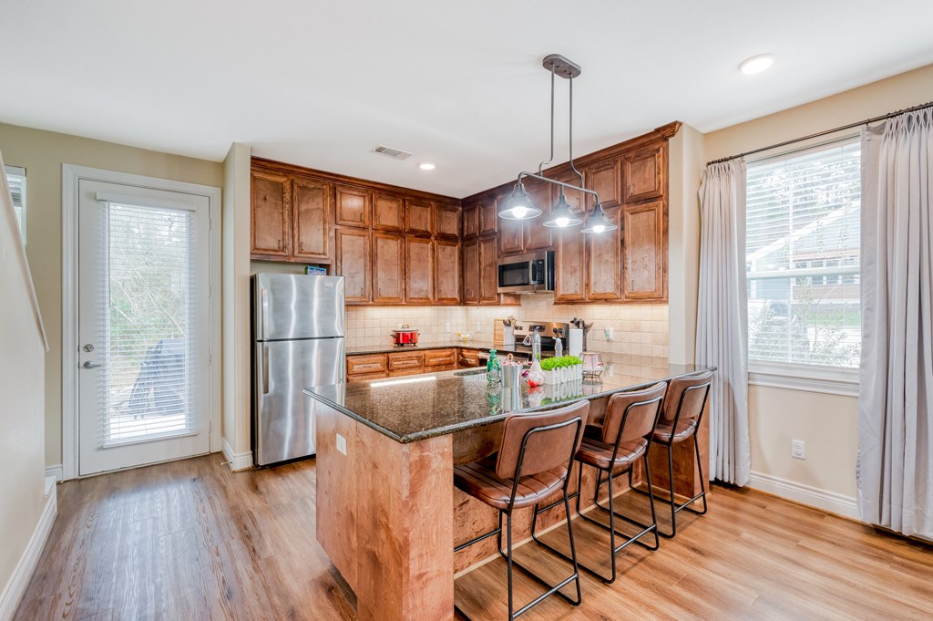 a kitchen with wooden cabinets and a granite counter top