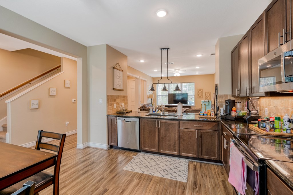 a kitchen with wooden cabinets and a counter top and a sink