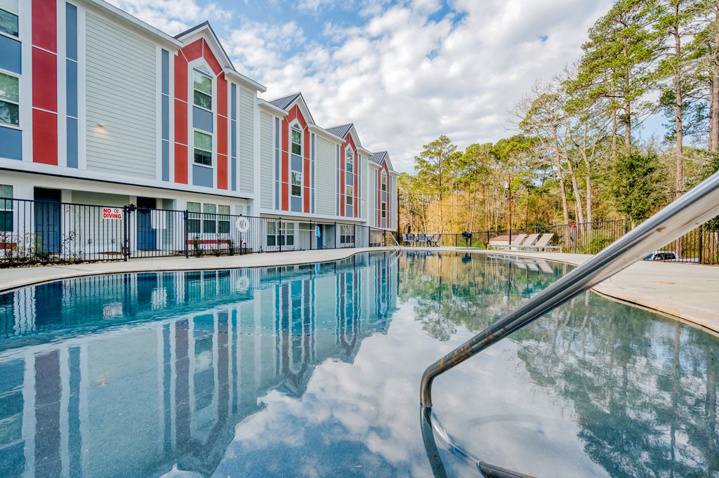 the preserve at ballantyne commons pool area with apartment buildings and trees