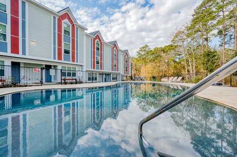 the preserve at ballantyne commons pool area with apartment buildings and trees