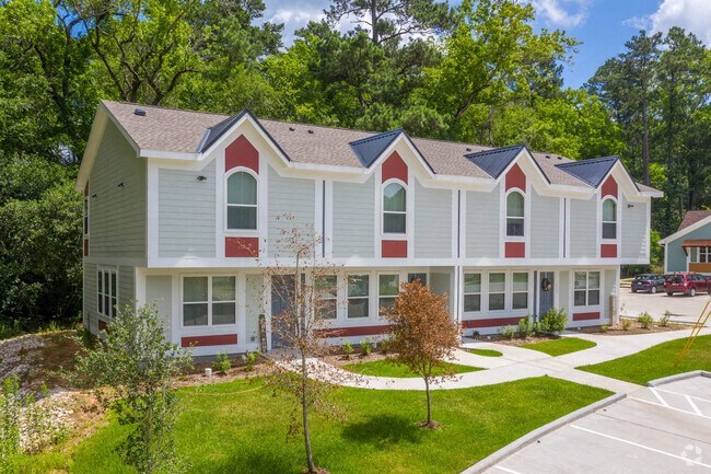 a white house with red and white siding and trees