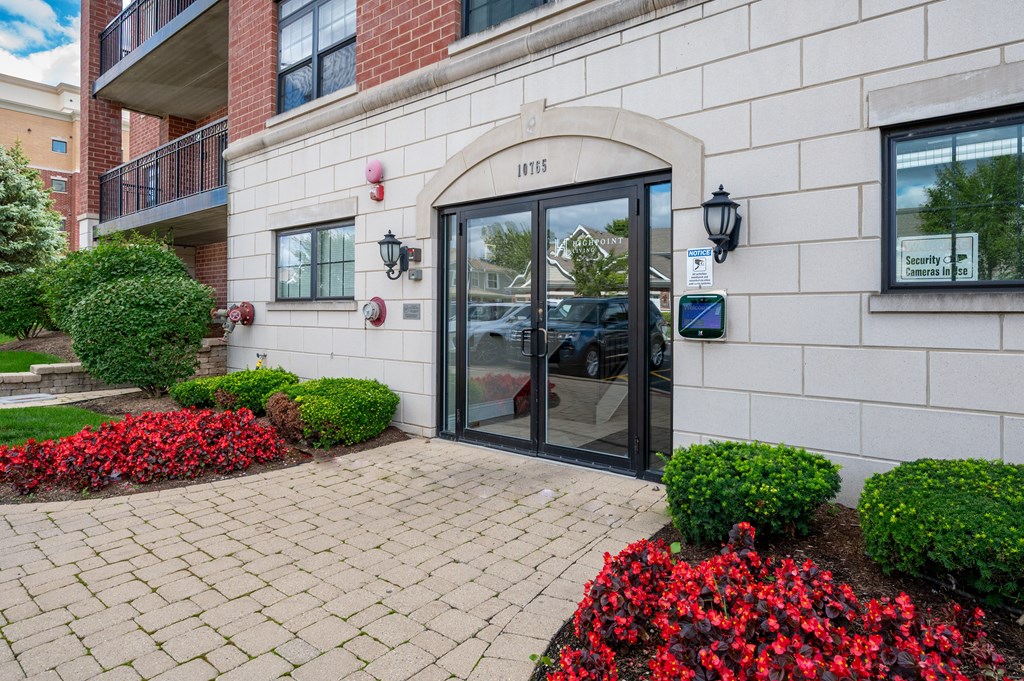 The front of a building with a black door and a sign that reads