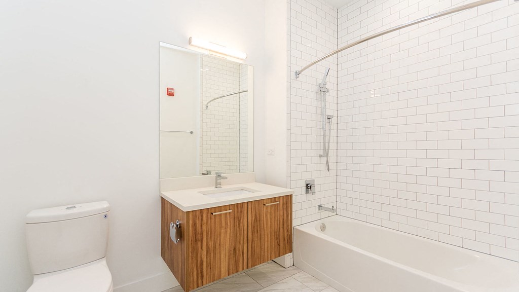 a white bathroom with a toilet sink and shower