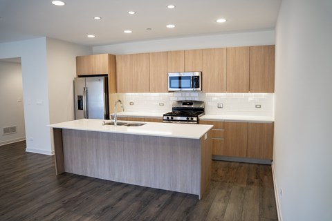 A modern kitchen with a wooden cabinet and a white countertop.