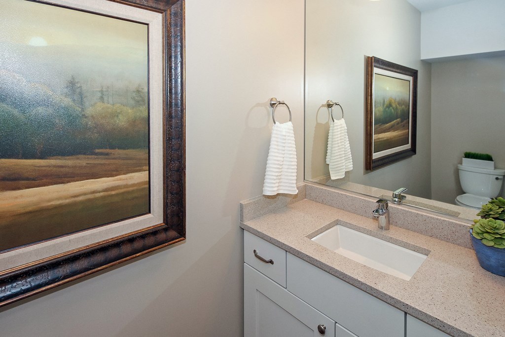 the second bathroom has a large mirror and a sink