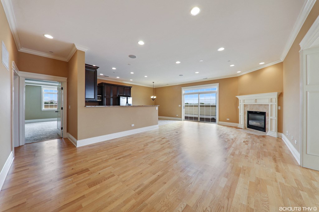 an empty living room with a fireplace and hardwood floors  at Countryside 10765, Countryside, IL