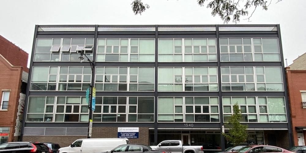 a large building with cars parked in front of it  at Fullerton 1540, Chicago, IL, 60614
