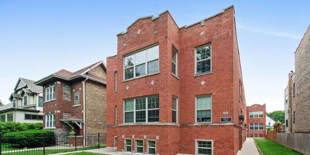 a red brick building with a sidewalk in front of it at Tripp 4321, Chicago, IL
