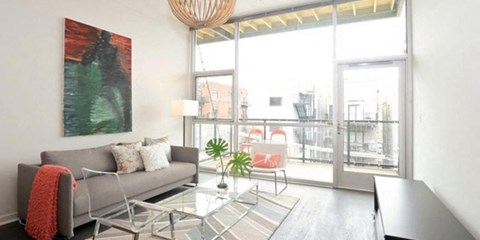 a living room with a couch and a glass table