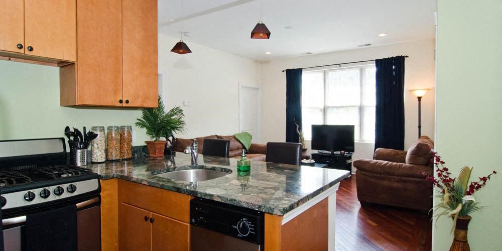 a kitchen and living room with a stove and sink at Tripp 4321, Chicago, 60641