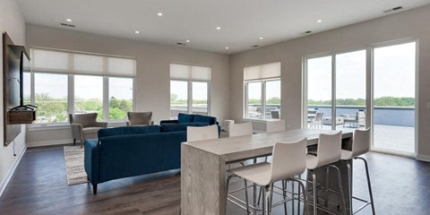 a living room and dining room with a table and chairs