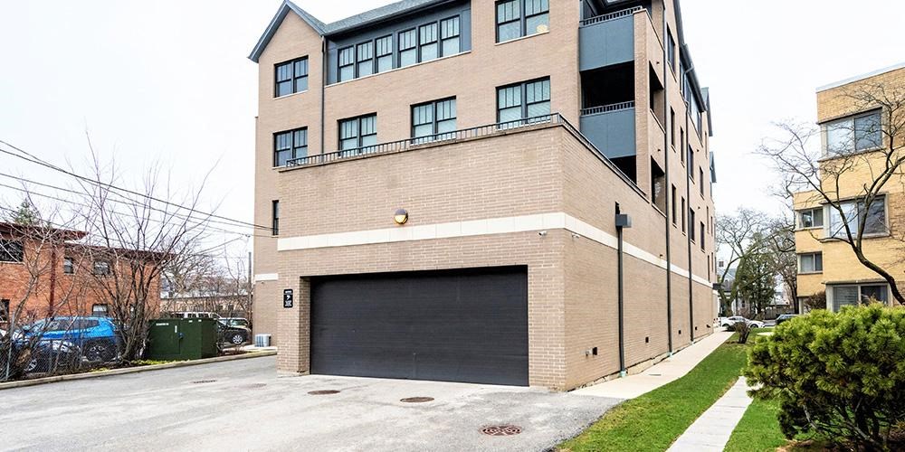 a large brick building with a garage door at Wilmette 1121, Wilmette, IL