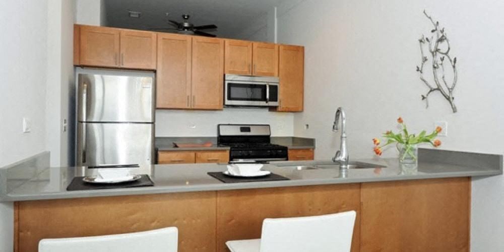 a kitchen with a sink and a refrigerator  at Fullerton 1540, Chicago, Illinois