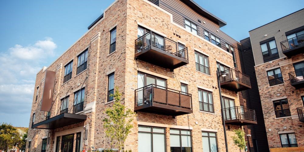 a brick apartment building with balconies at Barrington 101, Barrington Illinois