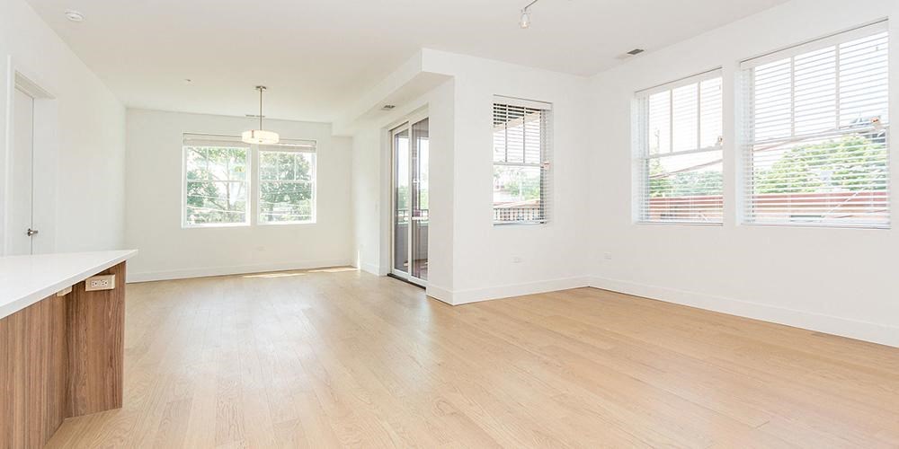 an empty living room with a hard wood floor