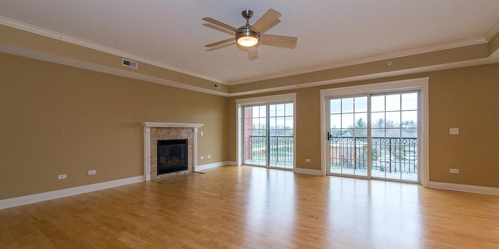 an empty living room with a fireplace and a ceiling fan  at Countryside 10765, Countryside, Illinois