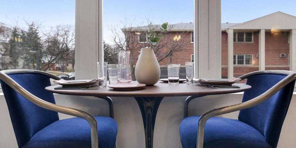 a table with two blue chairs and a white vase at Clarendon Hills 229, Illinois, 60514