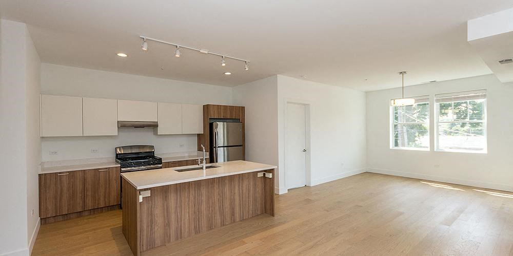 an empty kitchen with a sink and a refrigerator  at Wilmette 1121, Wilmette, Illinois