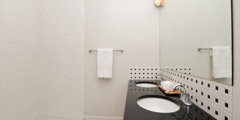a white bathroom with two sinks and a mirror  at Fullerton 1540, Chicago, IL