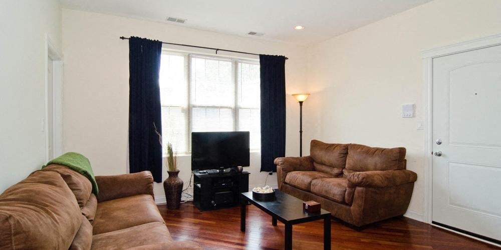 a living room with leather couches and a television at Tripp 4321, Illinois