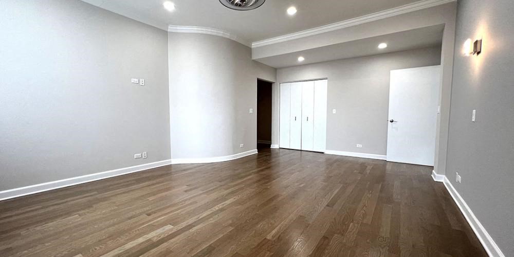 an empty living room with wood floors and white walls  at Lavergne 4810, Illinois, 60630