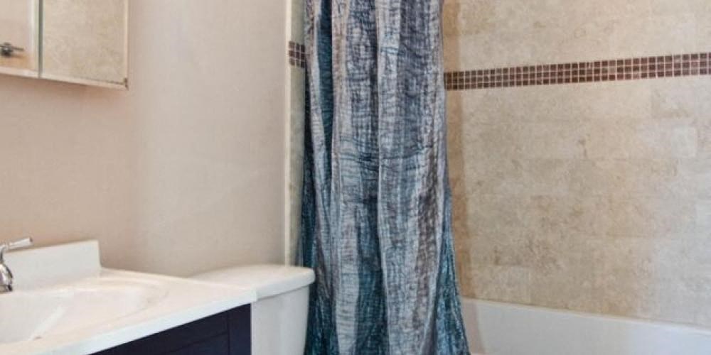 a bathroom with a shower curtain and a sink at Tripp 4321, Illinois