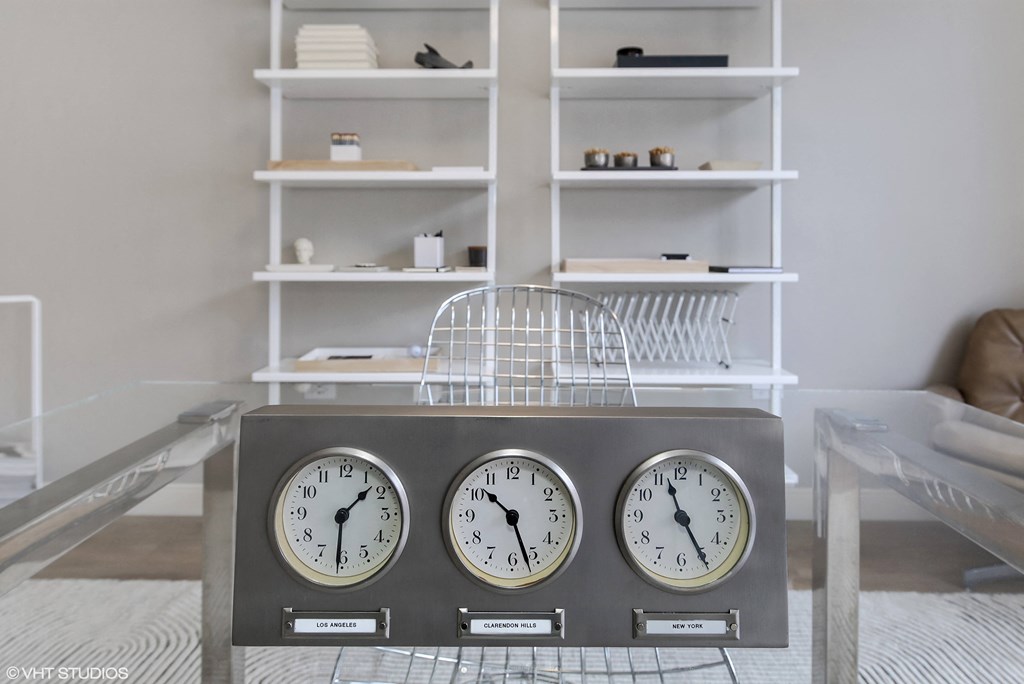 three clocks on a table in a living room at Clarendon Hills 229, Clarendon