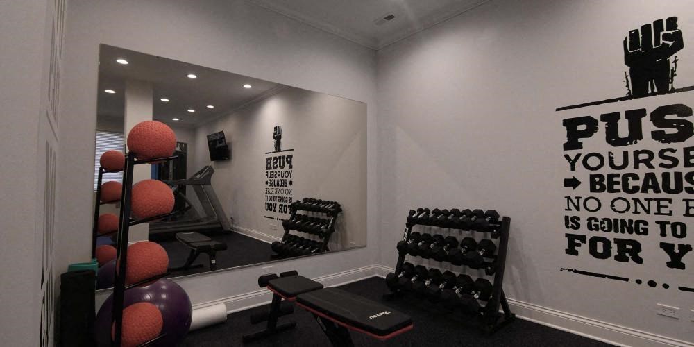 a gym with weights and a mirror on the wall  at Tripp 4321, Chicago, IL