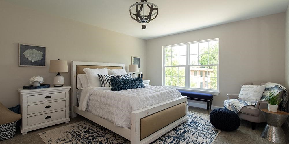 a bedroom with a bed and a window at Countryside Townhomes, Countryside