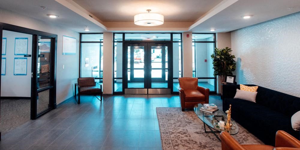 a lobby with a couch and chairs and a table at Barrington 101, Barrington, IL