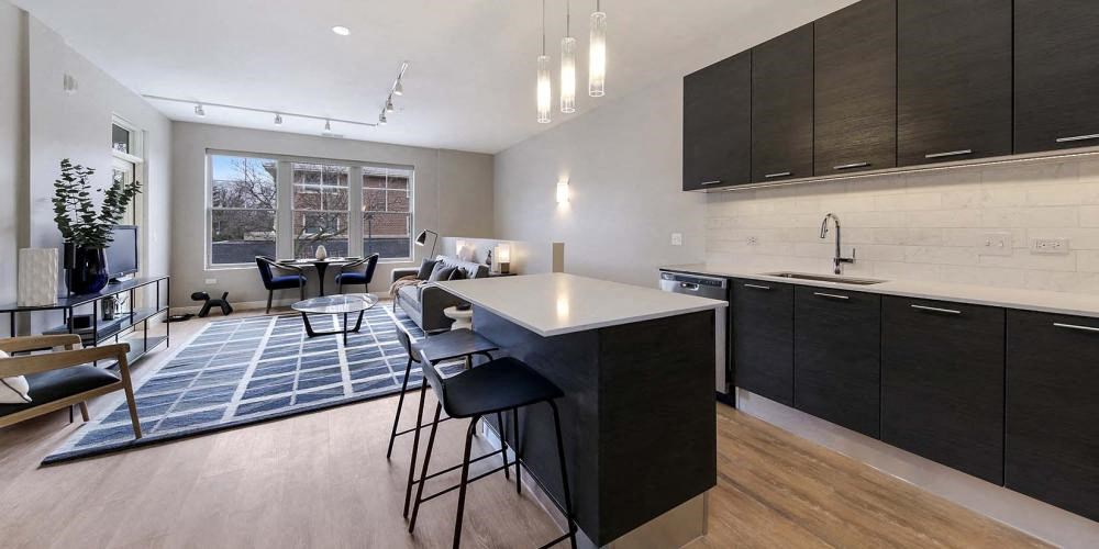 a kitchen with an island and a living room at Clarendon Hills 229, Clarendon, IL