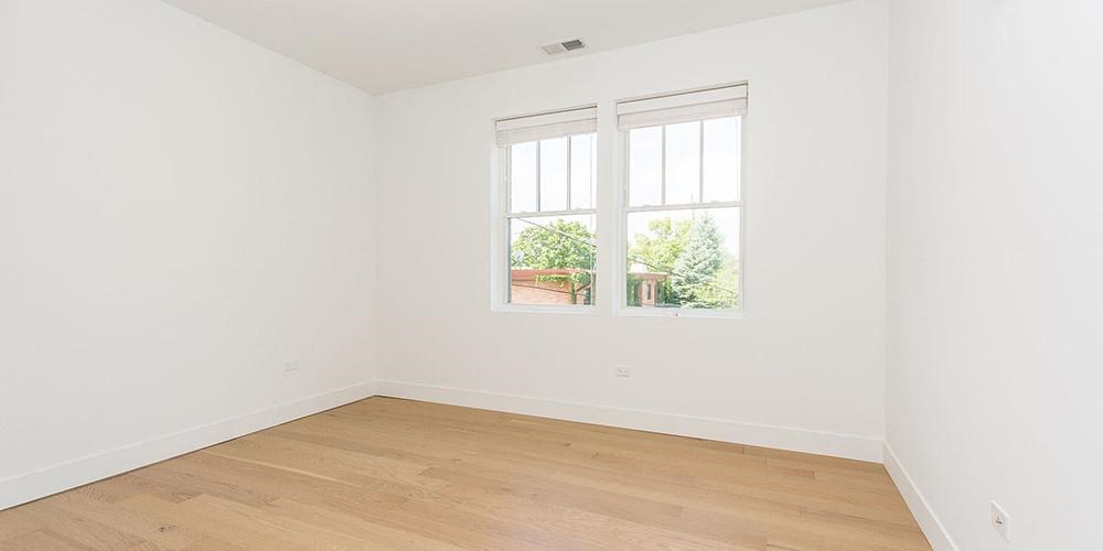 an empty room with a window and a wooden floor  at Wilmette 1121, Illinois