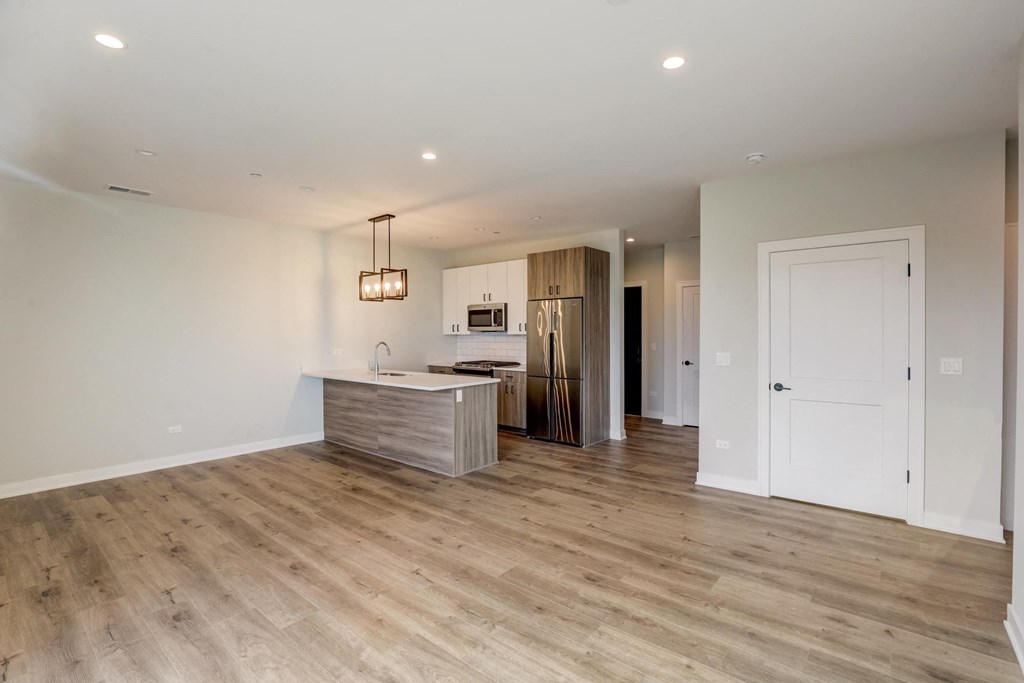 a living room with a kitchen and a door to a hallway at Highwood 440, Illinois, 60515