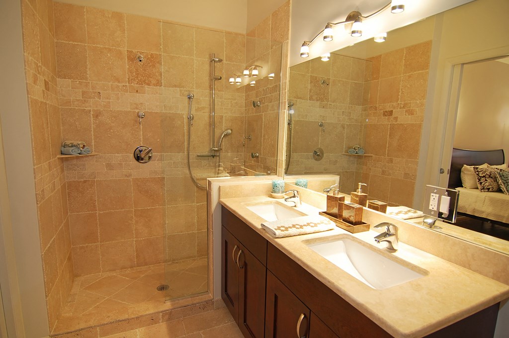 a bathroom with two sinks and a shower