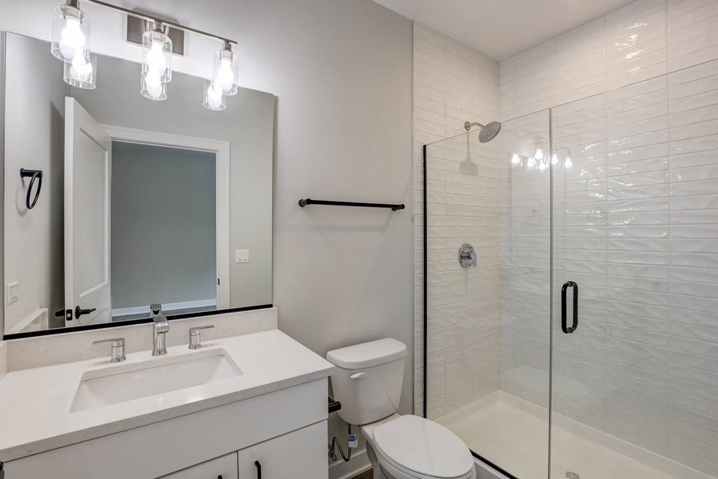 a white bathroom with a shower sink and toilet at Highwood 440, Highwood, 60515