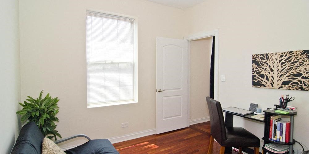 a living room with a desk and a window at Tripp 4321, Illinois
