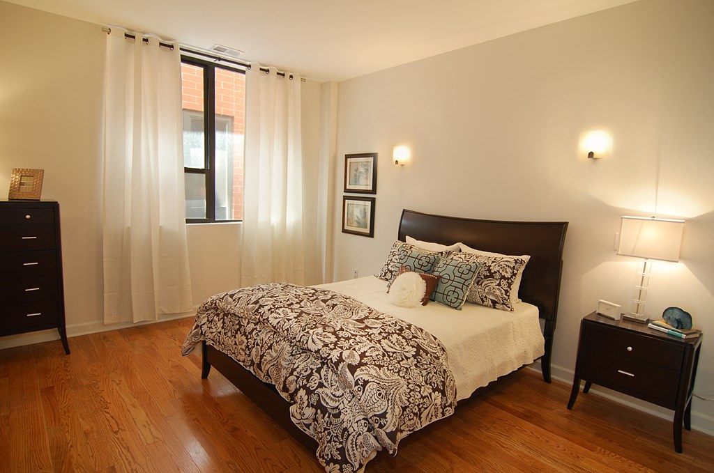 a bedroom with a bed and a window