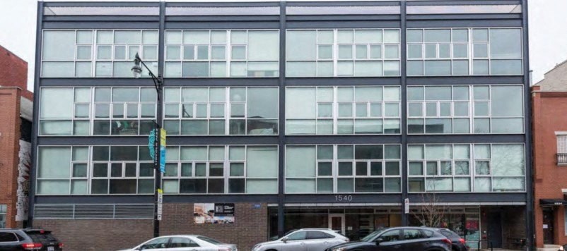 a tall building with cars parked in front of it  at Fullerton 1540, Chicago, Illinois