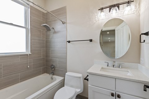 a bathroom with a sink toilet and a bath tub